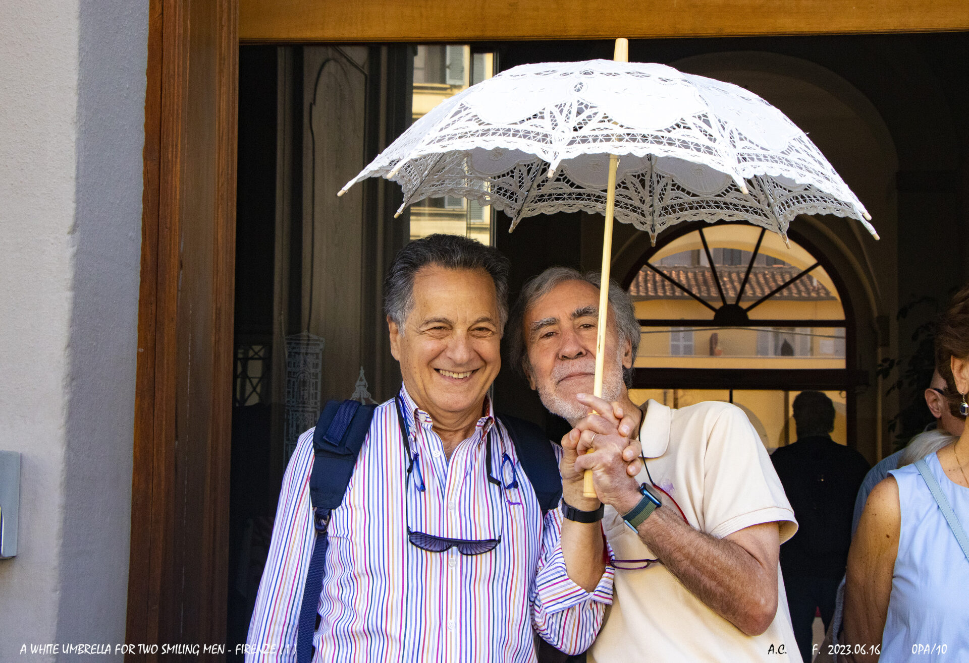 A white umbrella for two smiling men-Firenze(I)-0PAs